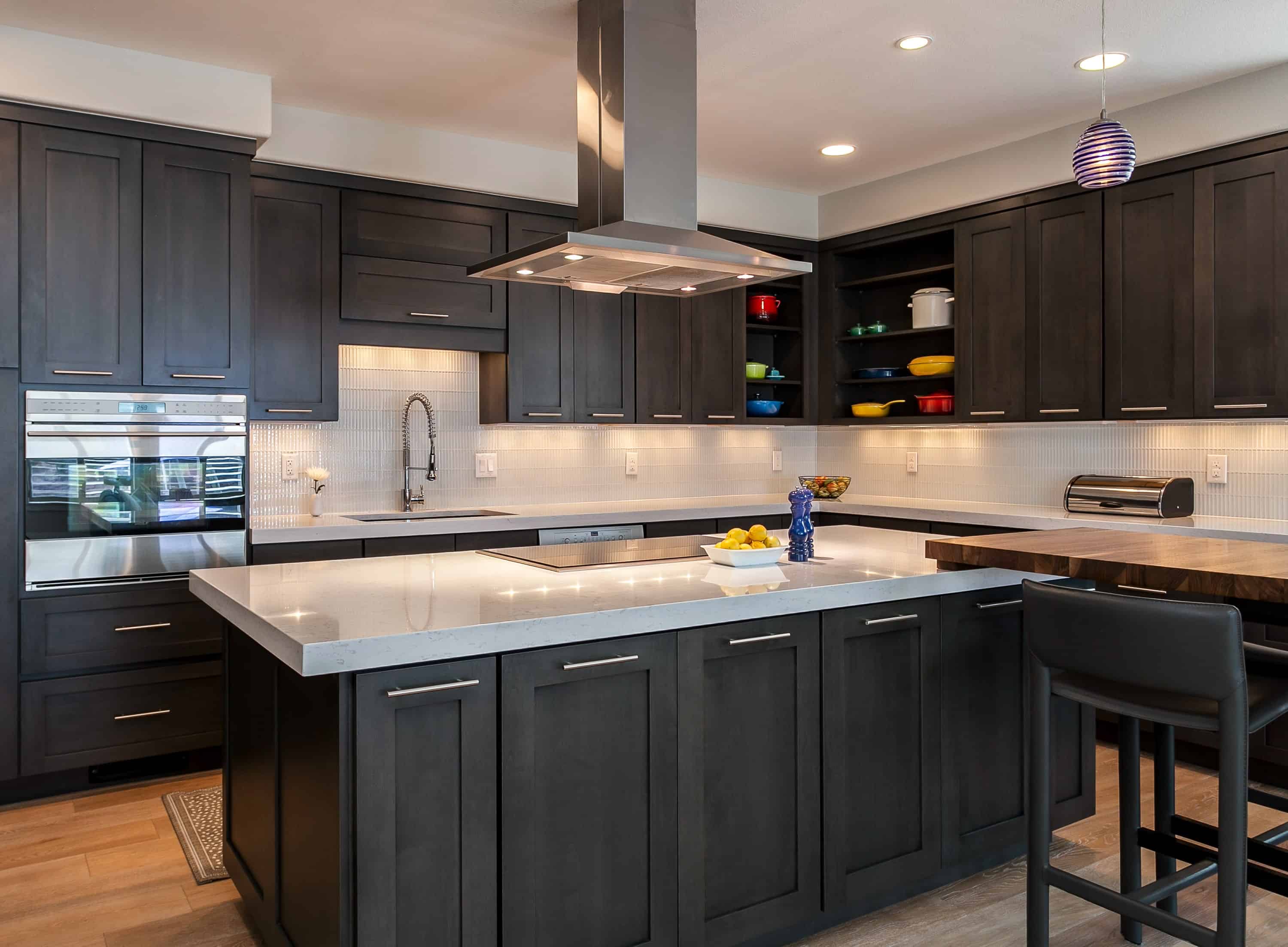 Black cabinet kitchen with unique tile backsplash