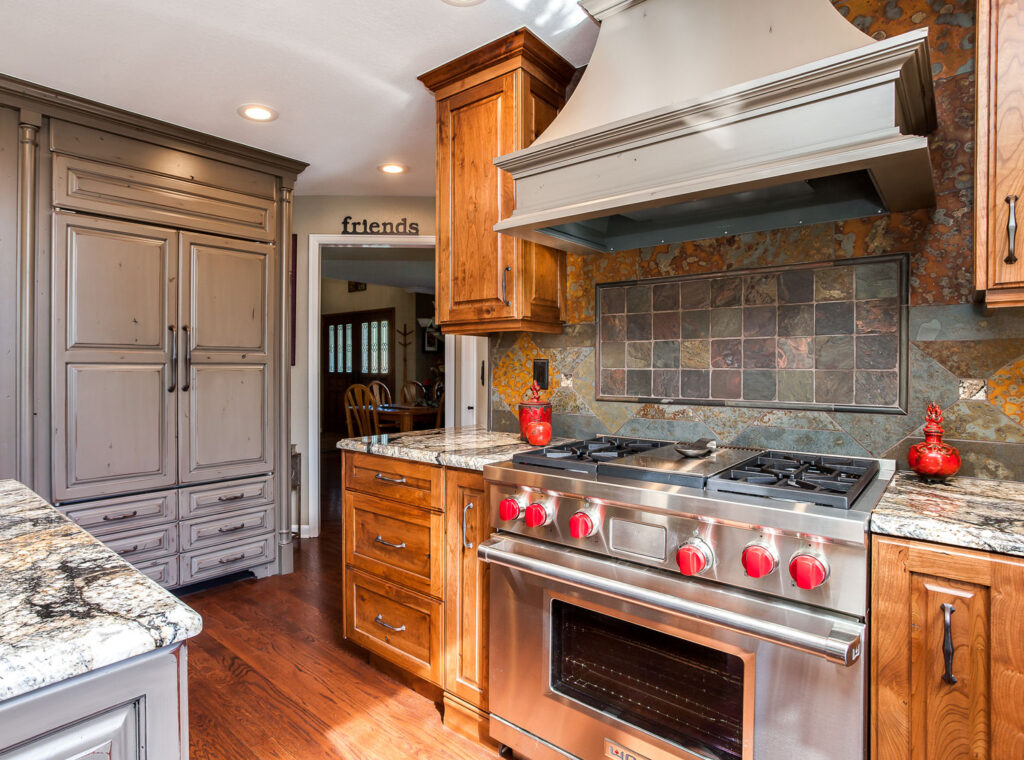 Range Hood above a Subzero Wolf Appliance package red knob stove
