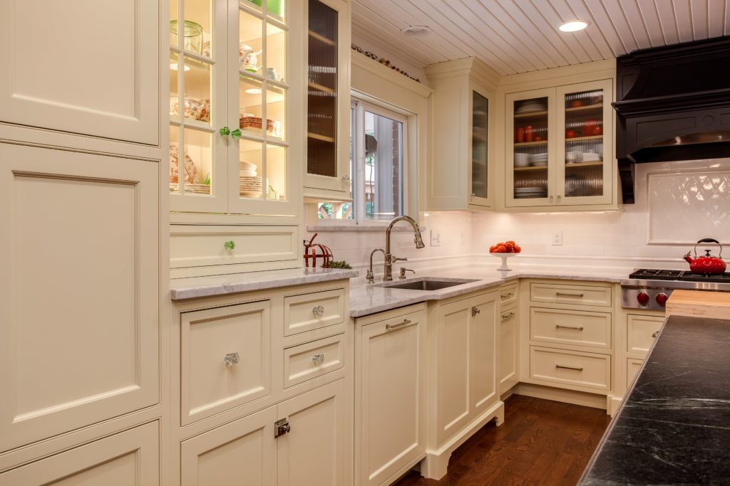 Off white shaker cabinets with textured glass. Shaker cabinets continue to be a kitchen remodeling trend for 2020
