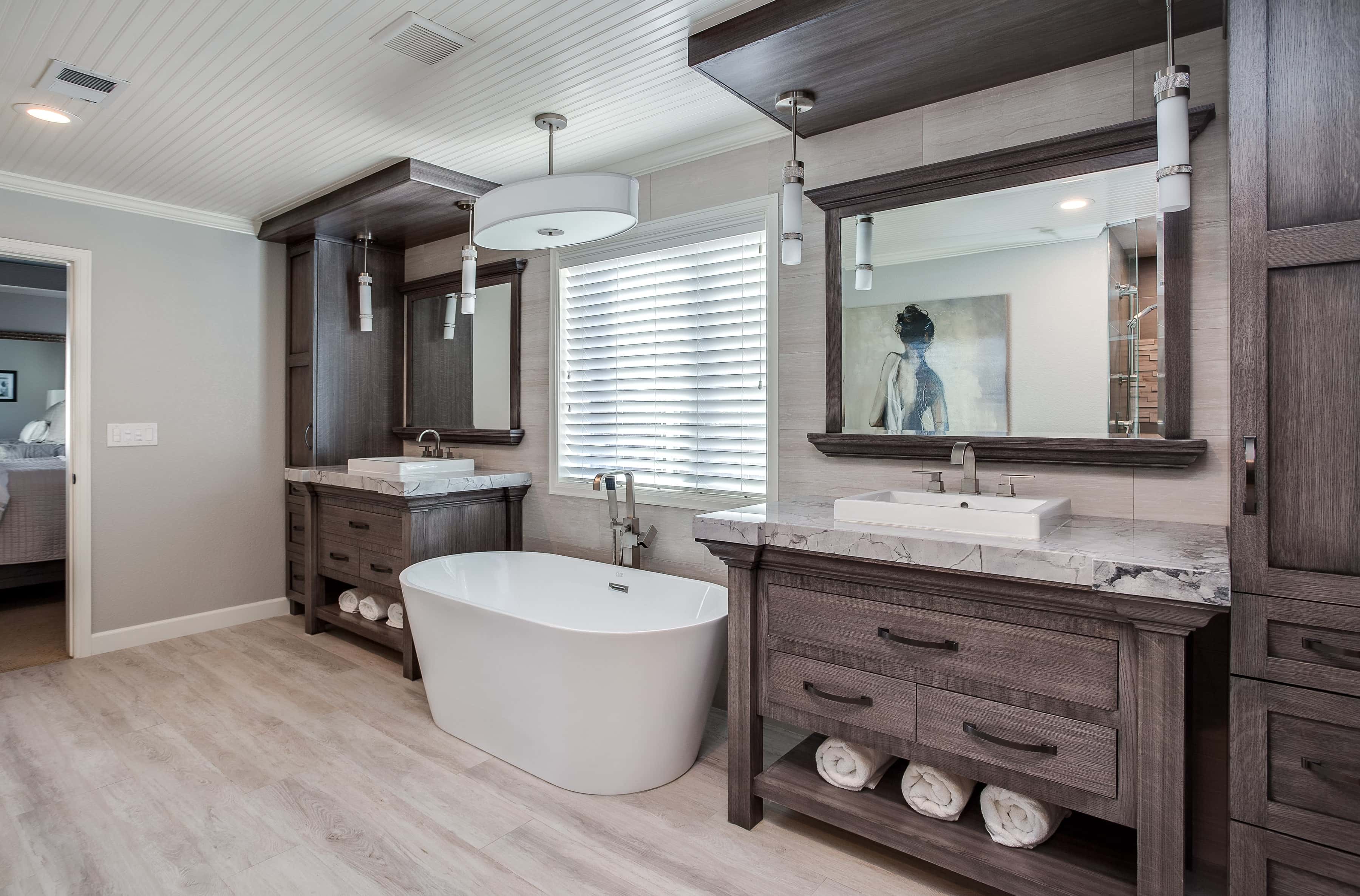 Master bath with custom built in vanities in natural wood