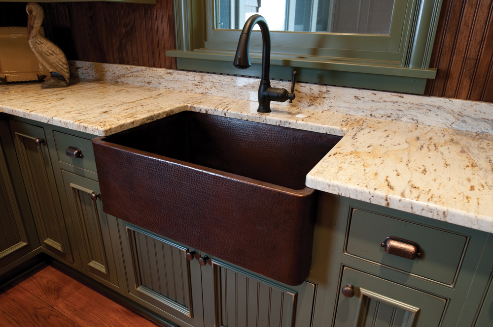 Copper Farmhouse sink in this Shaker style painted cabinet kitchen in our Castle Rock Colorado Showroom.